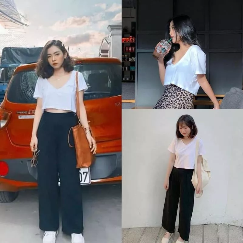 alt text: Cô gái mặc áo croptop form rộng màu trắng, quần jeans xanh và giày thể thao trắng.