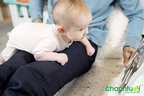 Bé tập tummy time trên đùi mẹ